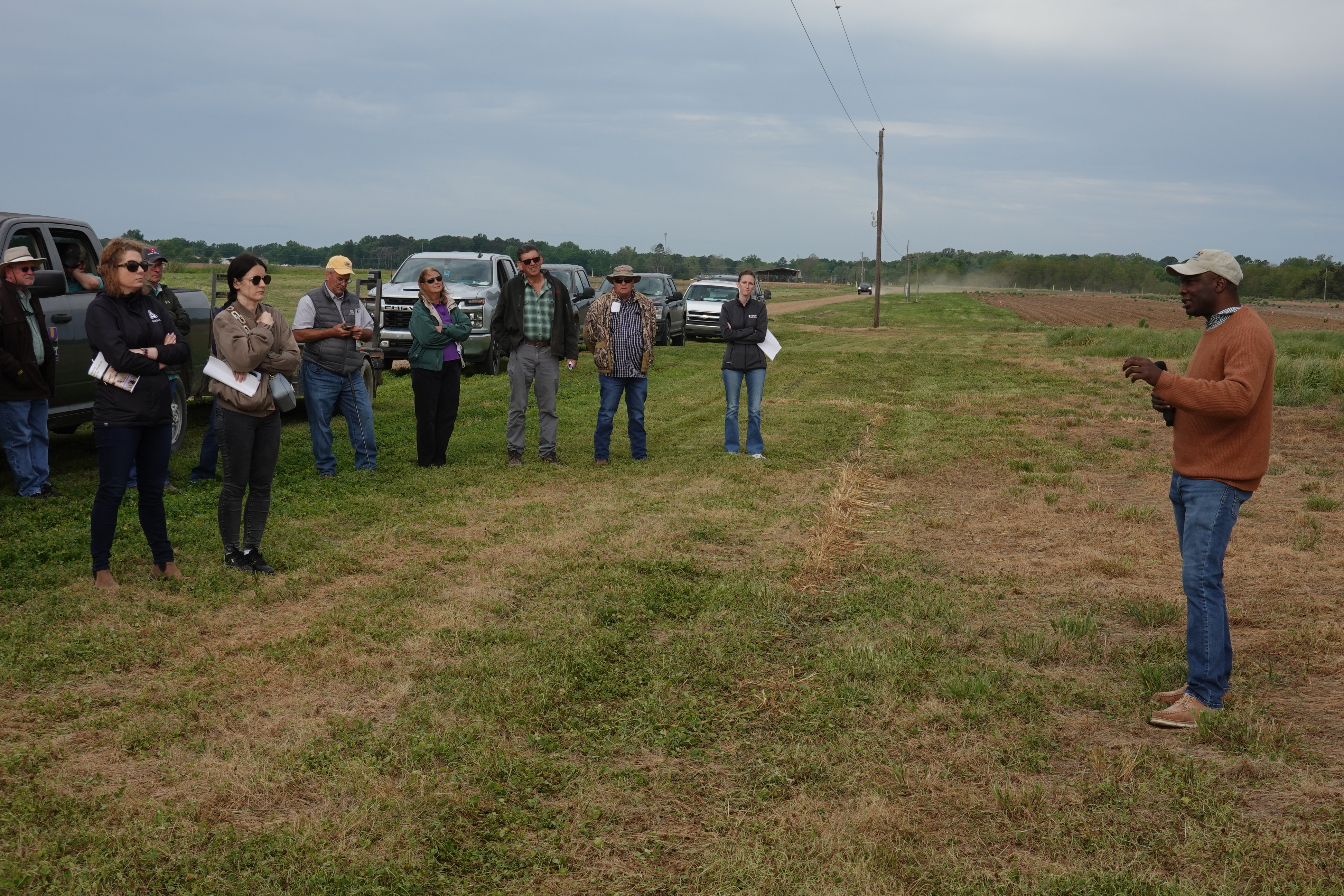 Man talking to farmers at field day.